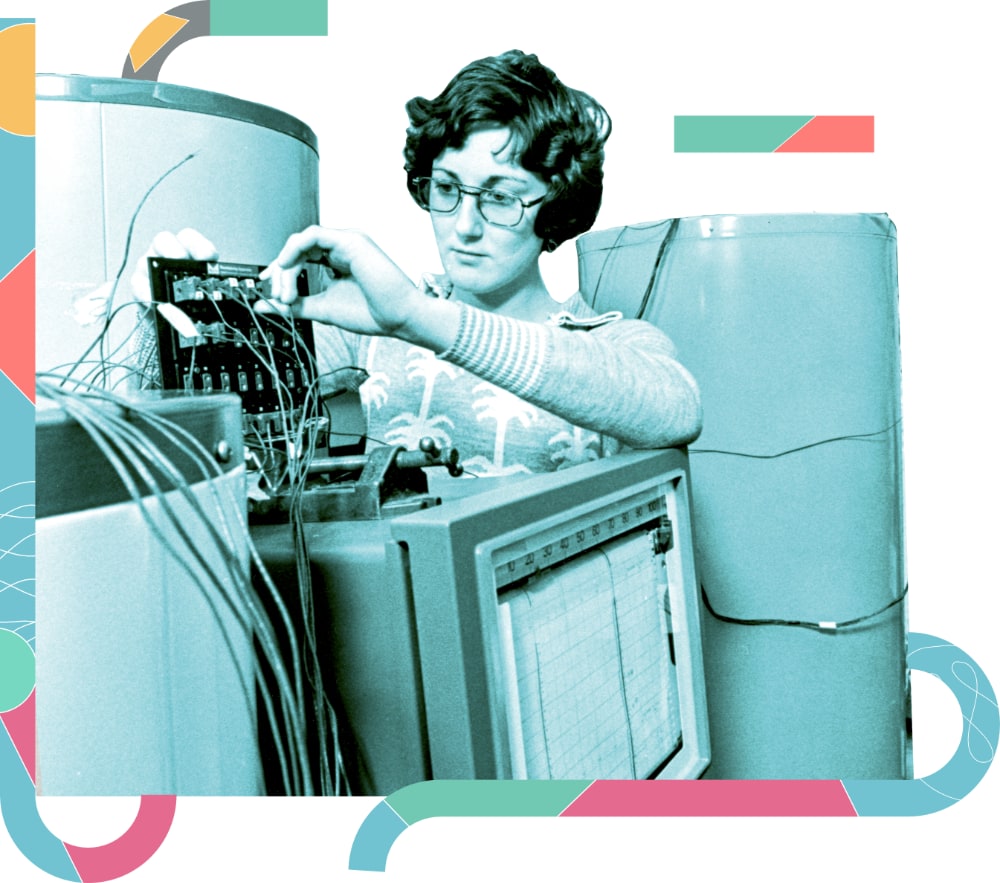A vintage duotone image of a woman working on a large mainframe